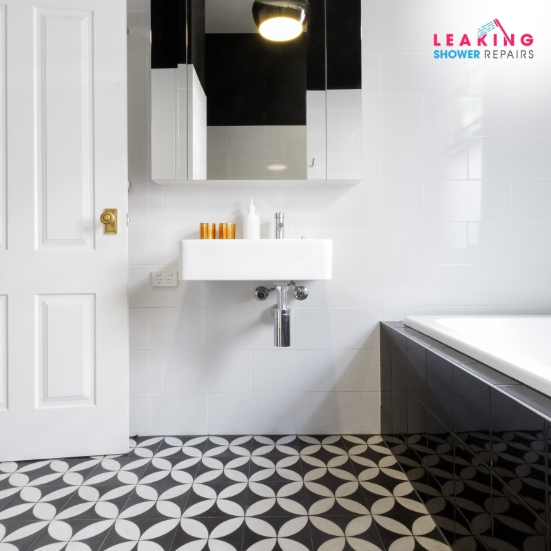 Trusted tiling company for quality work: Elegant black and white tiled bathroom with a patterned floor.