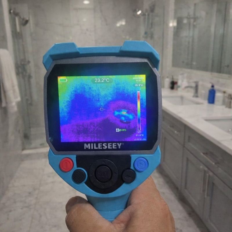 Thermal inspection camera identifying moisture behind bathroom tiles and vanity area