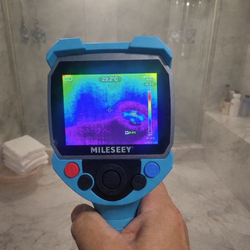 Handheld thermal camera identifying hidden moisture during water leak detection