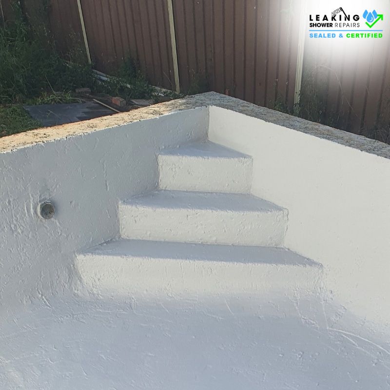 Waterproofing application on concrete pool steps, showcasing a newly coated, smooth surface designed for enhanced water resistance.